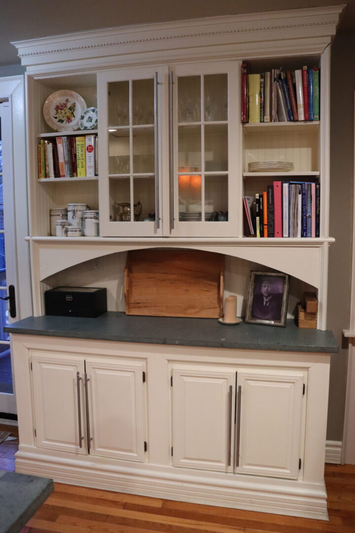 White shelf cabinet with a black countertop