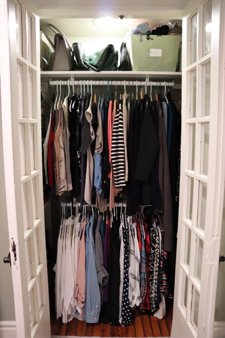 Two levels of hanged clothes in a closet