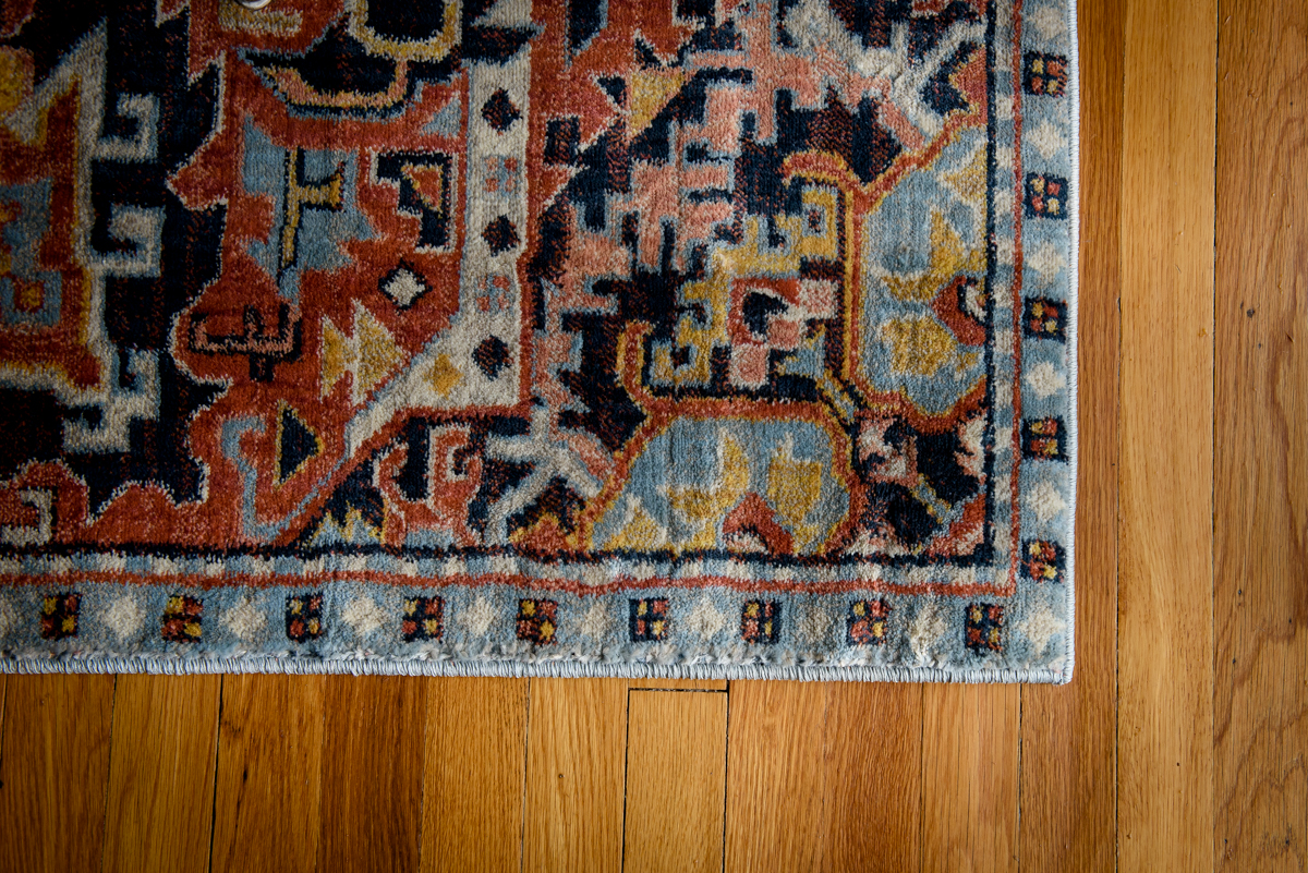 Colorful woven rug on a wooden floor